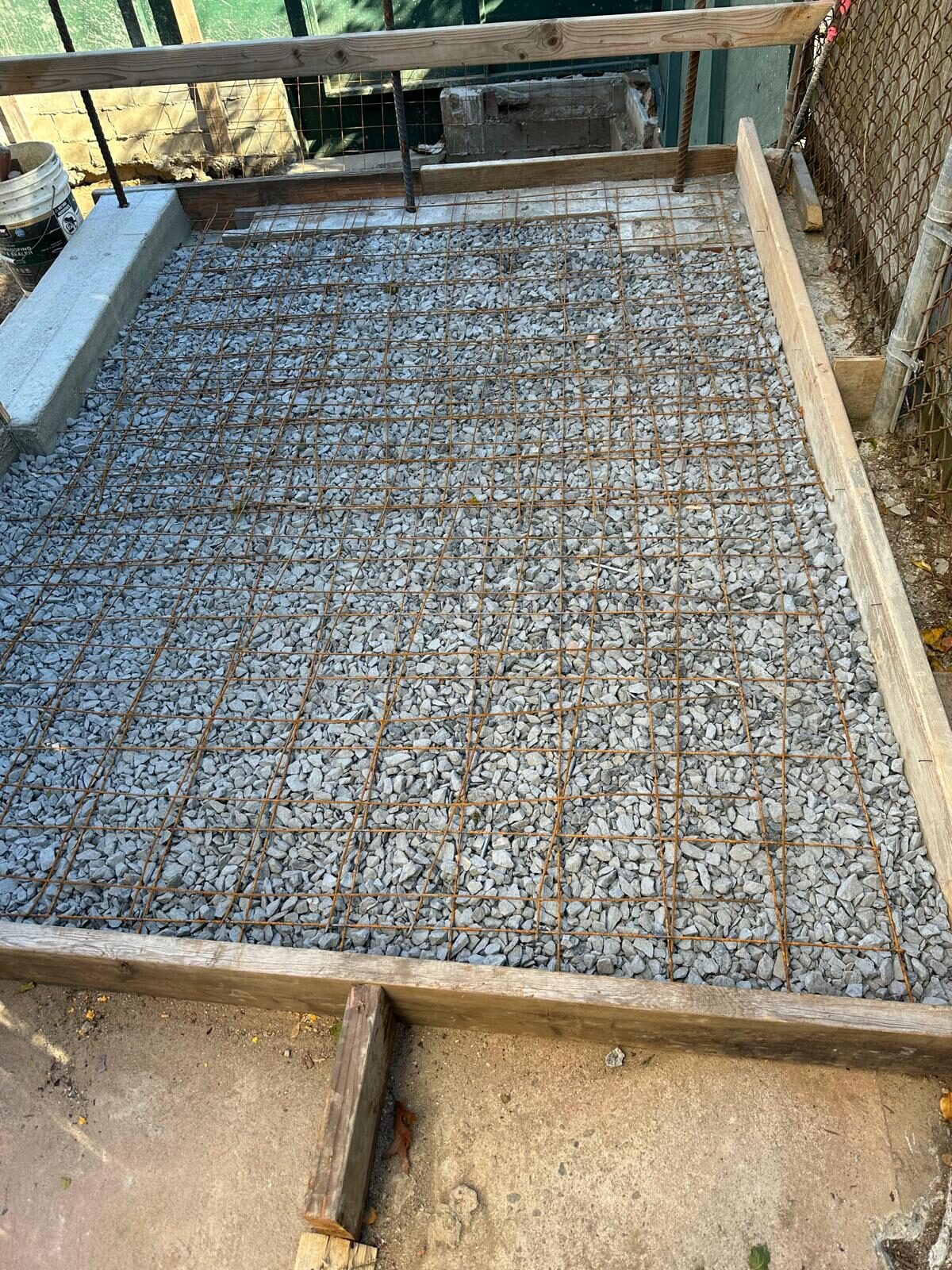 Gravel and rebar base prepped for patio slab - Nassau County